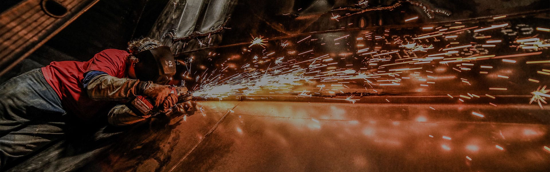 A Northern Plains Railroad welder repairing a locomotive